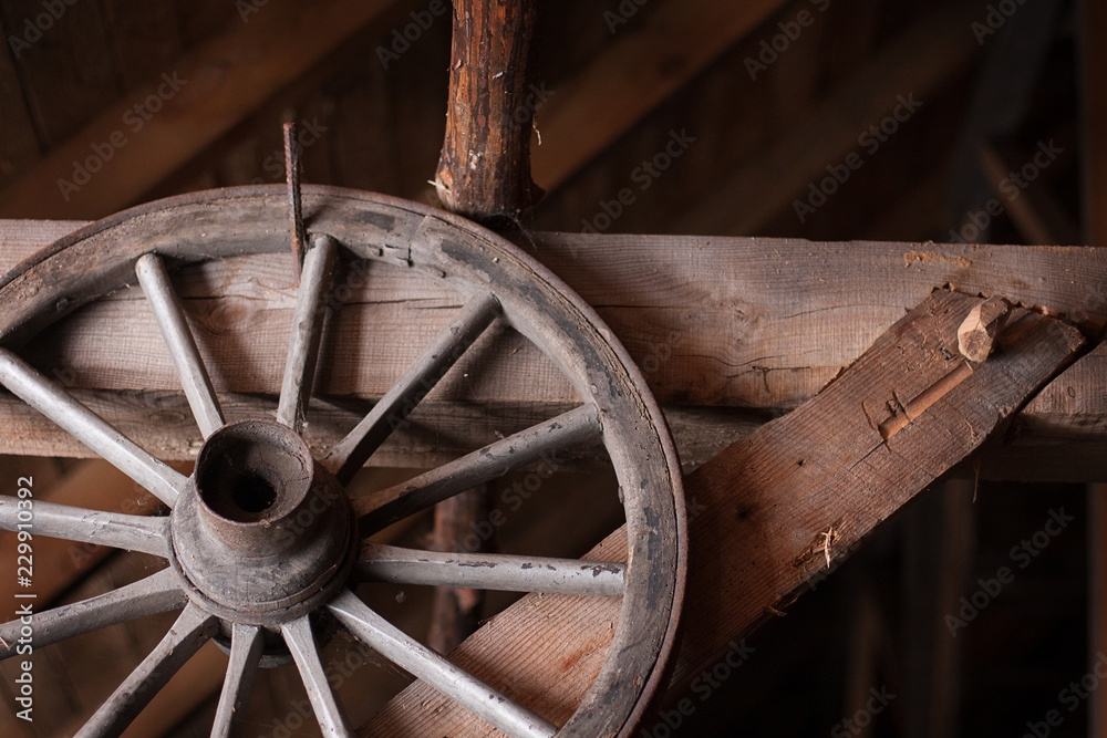 Panoramic composition of old wooden objects on which is a wooden wheel, old barrel, plowing, straw basket Panoramic composition of old wooden objects on which is a wooden wheel, old barrel, plowing, straw basket