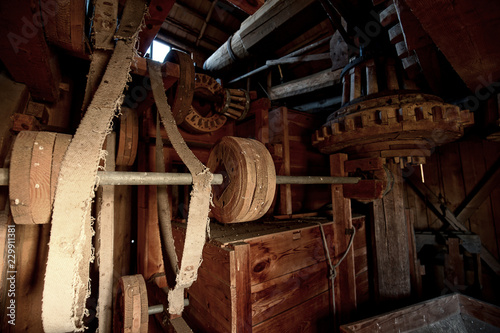 The original, wooden mechanism of an old windmill, grain mill