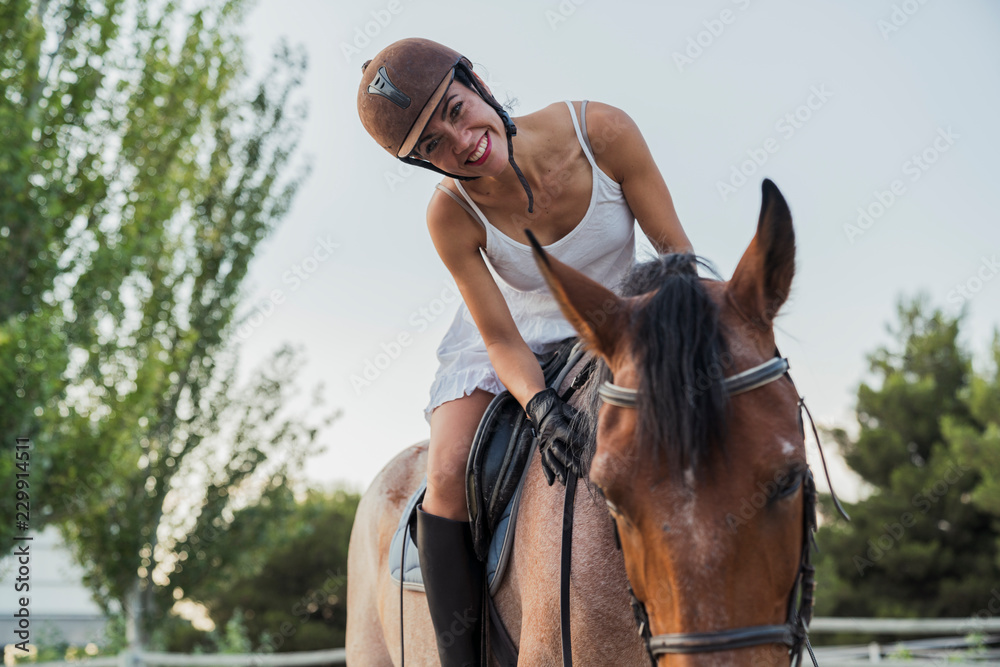 Portrait of happy woman riding on horse Portrait of happy woman riding on horse