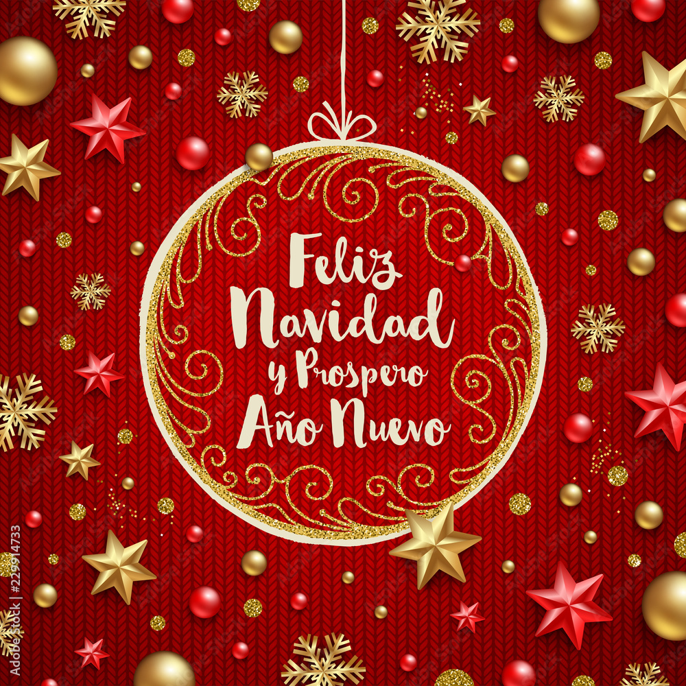 Feliz navidad - Christmas greetings in Spanish. Holiday greeting in a ornate frame and Christmas decoration on a knitted red background.
