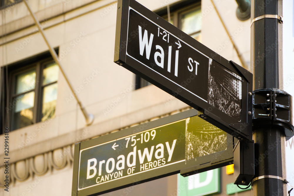 Street signs at the intersection of Wall St. and Broadway in Manhattan, New York Street signs at the intersection of Wall St. and Broadway in Manhattan, New York