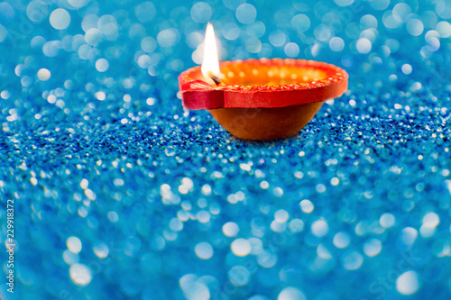 Happy Diwali Clay Diya lamps lit during Dipavali Hindu festival of lights celebration