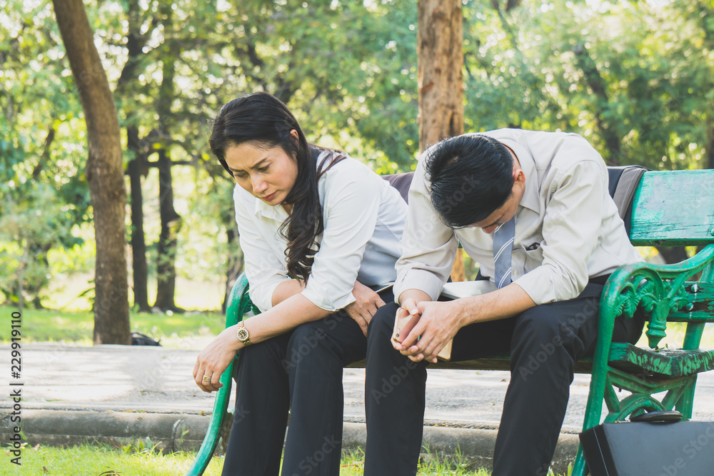 Asian businessman feeling stress outdoor in park Asian businessman feeling stress outdoor in park