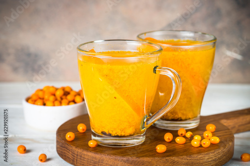 Sea buckthorn tea with orange in a glass cups.