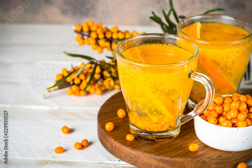 Sea buckthorn tea with orange in a glass cups.