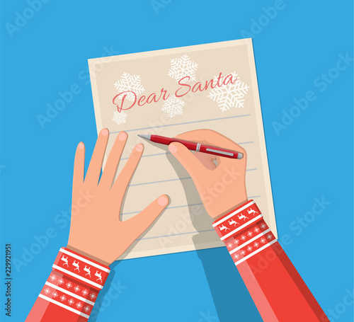 Child hand pen writing letter to santa claus.