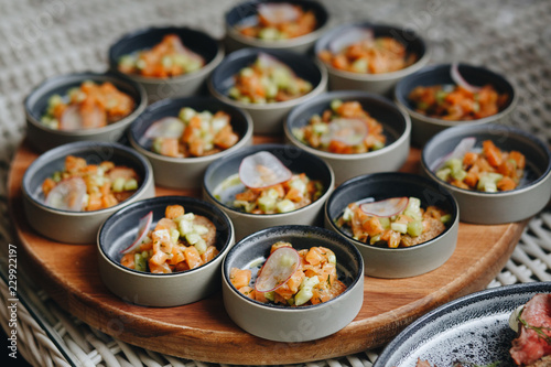 salmon Tartar with avocado in small plates for Banquet.