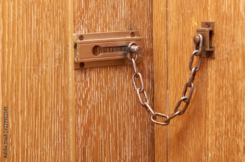 metal chain lock on the wooden front door