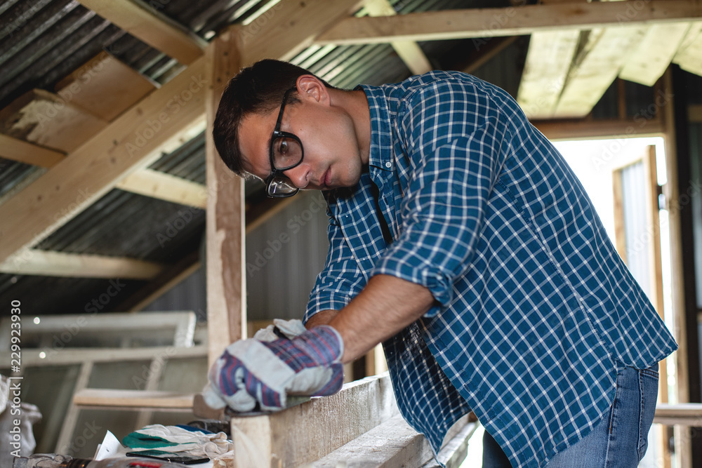 Joinery. The carpenter planes the wood in the workshop. Woodworking, roofing, diy. Joinery. The carpenter planes the wood in the workshop. Woodworking, roofing, diy.