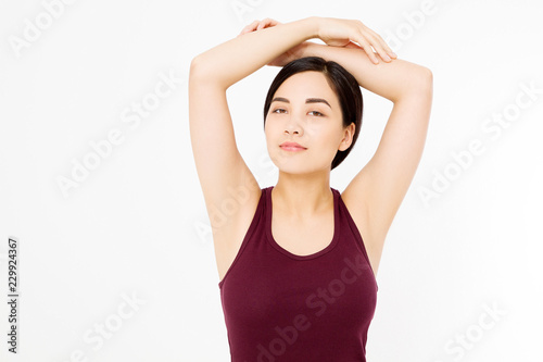 Skin care and armpit concept. Make up and cosmetics. Young asian woman isolated on white background in summer shirt. Copy space.