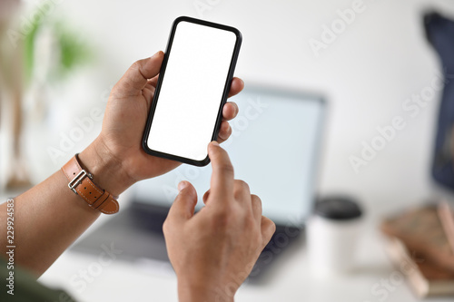 Businessman's hand using blank white screen mobile smart phone.
