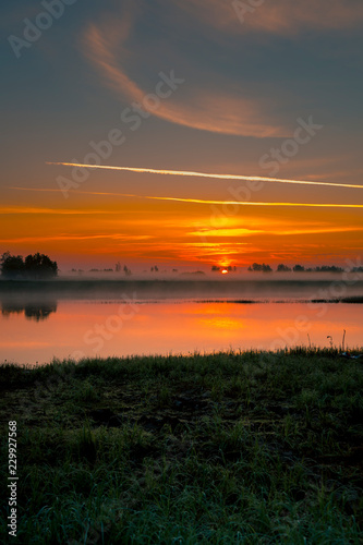 Dawn over a small river on a foggy morning © ads861