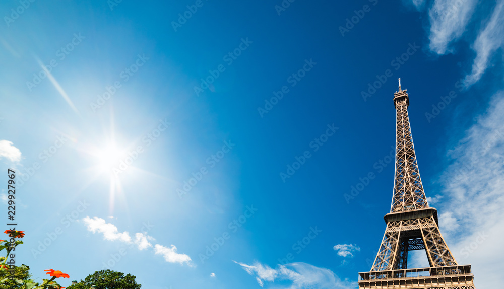 Sun shining over world famous Eiffel tower in Paris