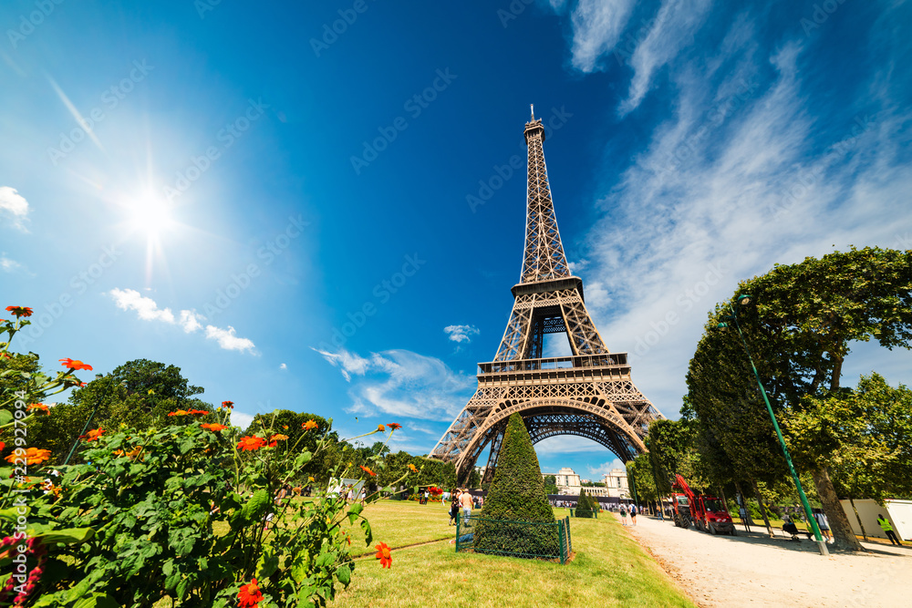 Fototapeta premium Sun shining over world famous Eiffel tower in Paris