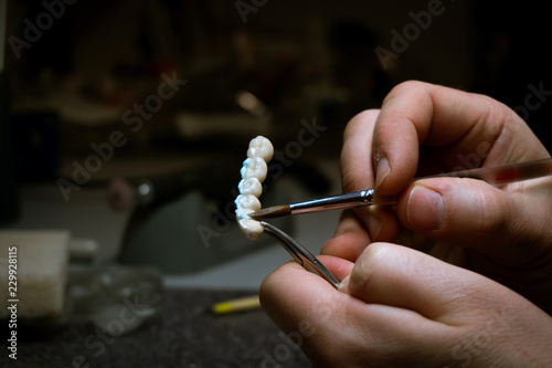 dental technician will design dental crowns. close-up. laboratory.