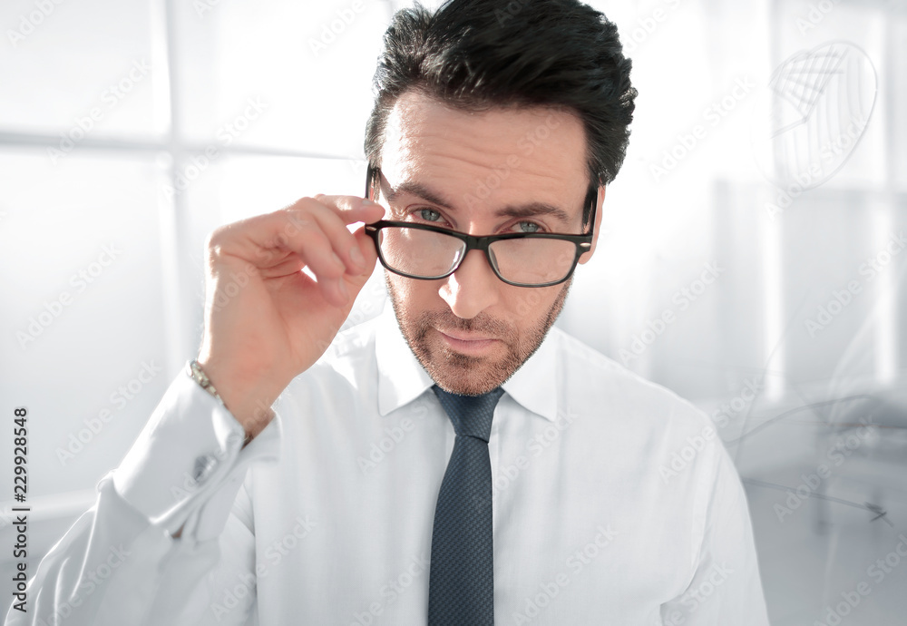 attentive businessman standing in the office. attentive businessman standing in the office.