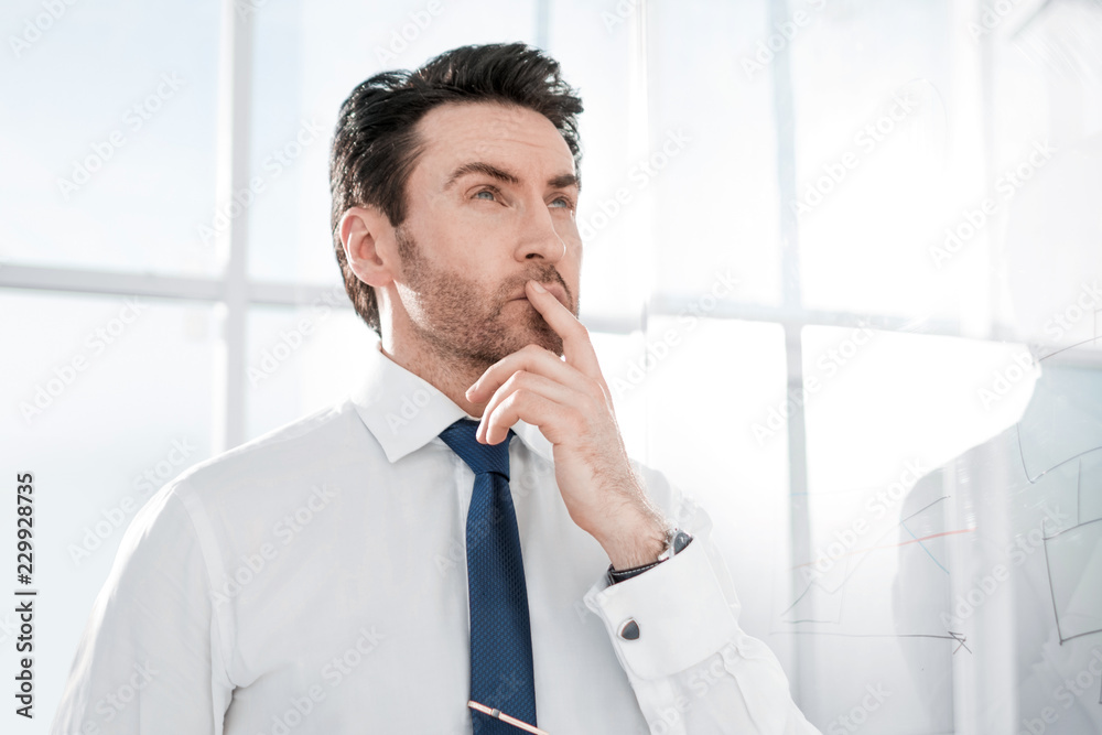 dreaming businessman standing in the office. dreaming businessman standing in the office.