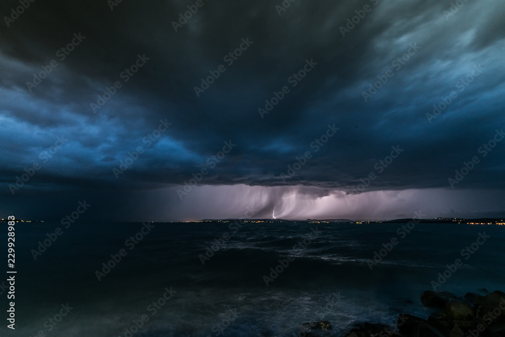 Storm and thunder over Lake Balaton dark clouds over sea wide angle nature photo