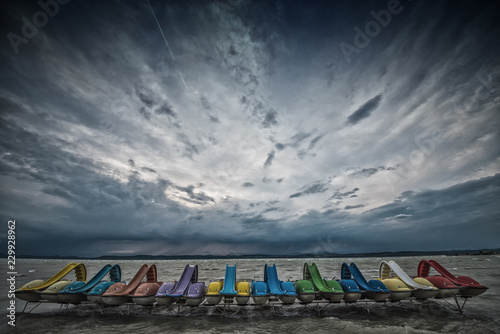 Paddle boats in the dock on Lake Balaton with cloudy sky