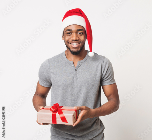 Happy black man holding christmas gift box