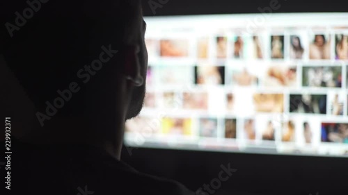 Young mand watching naked women in the computer screen