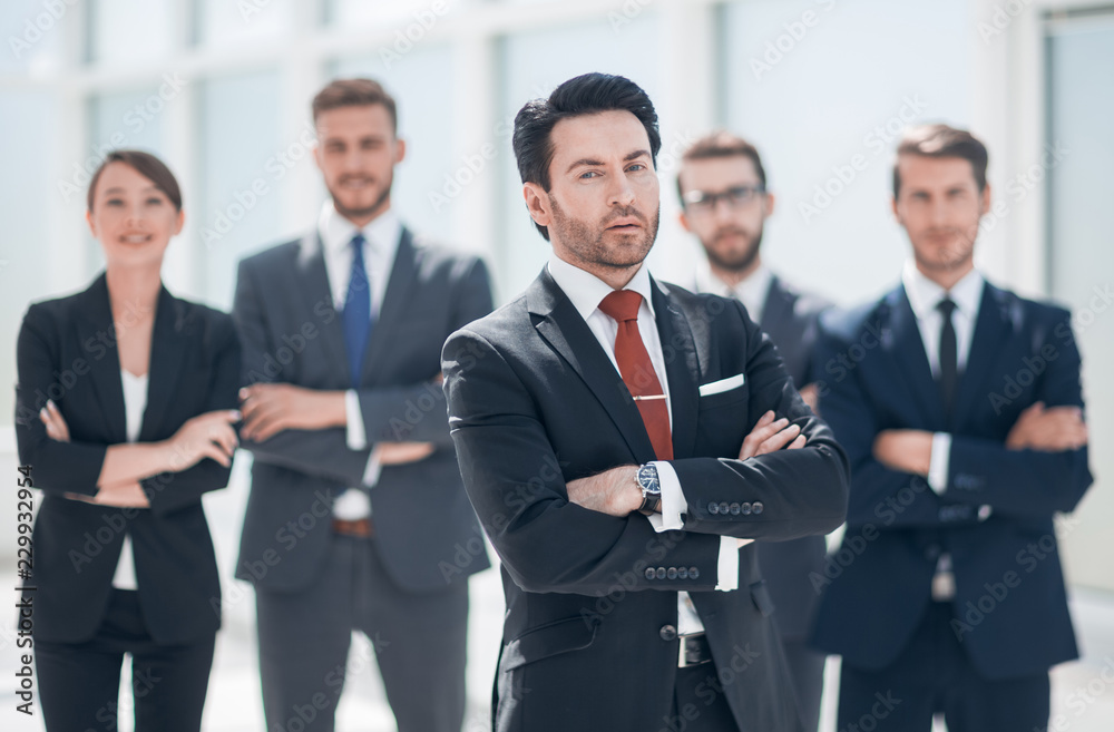 confident businessman in front of his business team confident businessman in front of his business team