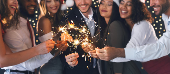 Friends in New Year eve with sparkling bengal lights