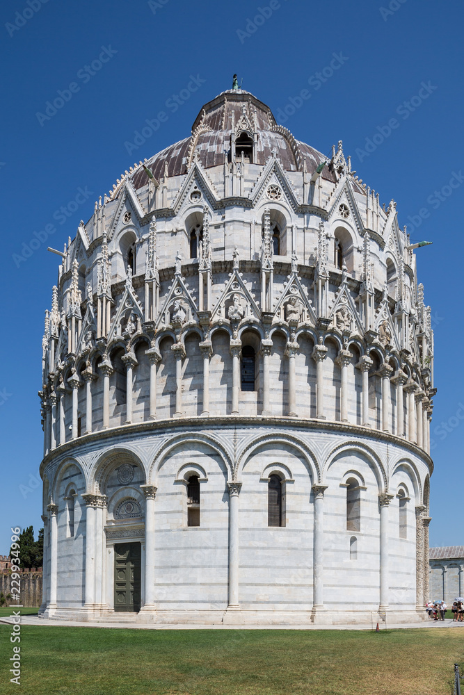 Tourists at the famous Pisa Baptistery of St. John, a Roman Catholic ecclesiastical building in Pisa, Italy.