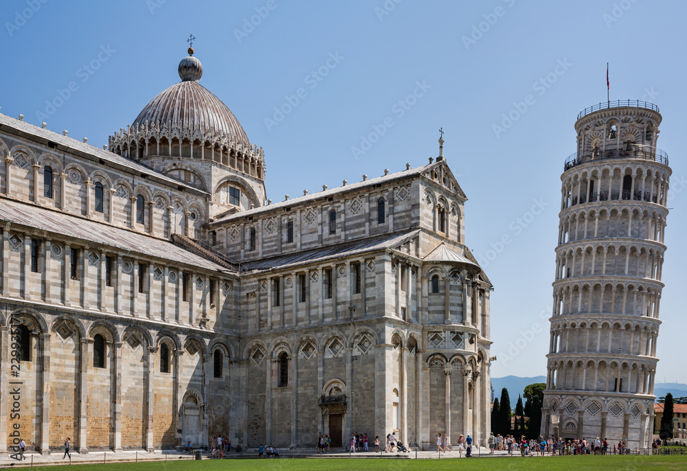 Tourists at the famous Pisa Cathedral, a medieval Roman Catholic cathedral  in the Piazza dei Miracoli in Pisa, Italy, located next to the famous leaning tower