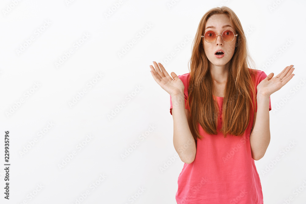 Studio shot of impressed and amazed stylish good-looking redhead girl with freckles raising spread palms and gasping from thrill seeing incredible and awesome performance starting clapping Studio shot of impressed and amazed stylish good-looking redhead girl with freckles raising spread palms and gasping from thrill seeing incredible and awesome performance starting clapping