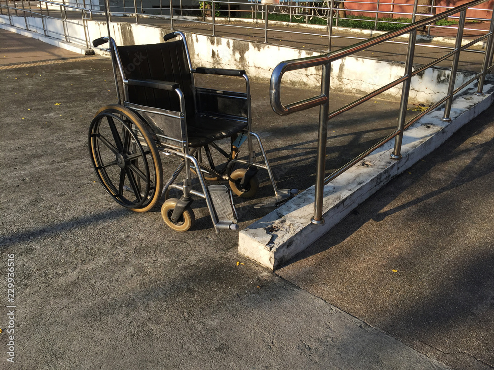 An old wheelchair parking near the ramp