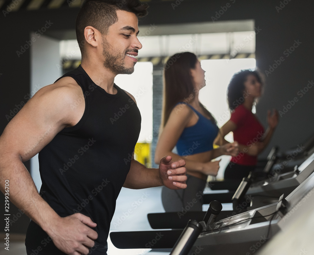 Sport concept. Happy man exercising on treadmill Sport concept. Happy man exercising on treadmill