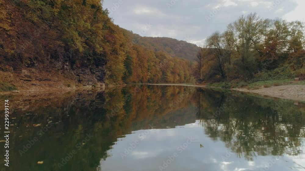 Aerial view: Flying along the river. Incredible colorful autumn view Aerial view: Flying along the river. Incredible colorful autumn view
