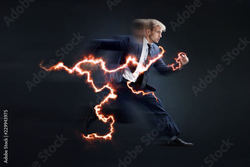 Fast business. Running businessman charged with lightning, concept