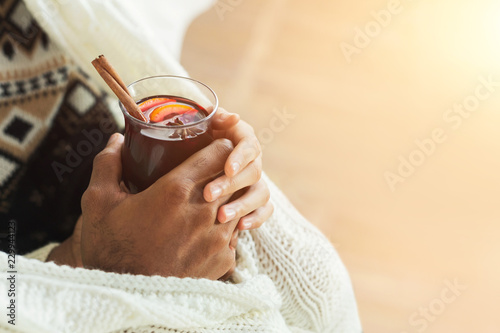 Man drinking hot red mulled wine