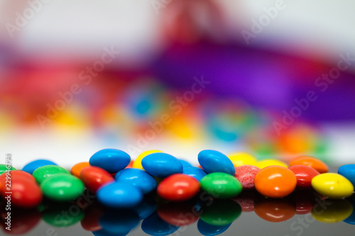 colorful chocolate buttons on a white background