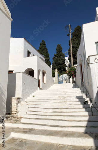 White marble stone staircase in Pyrgos town in Tinos island in Greece in a sunny day with blue sky.