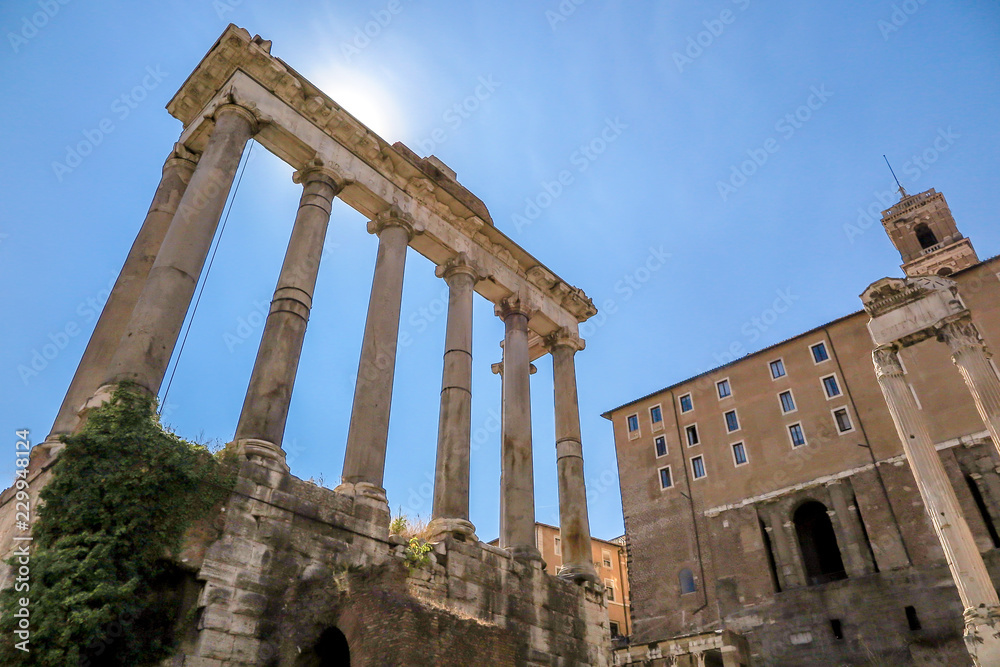 Marble columns of the Temple of Saturn, with the Palazzo Senatorio. Rome Italy.