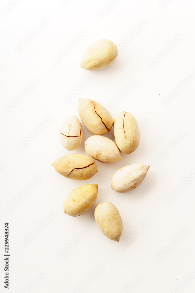 Pecan nuts in nutshells isolated. Overhead image, white background Pecan nuts in nutshells isolated. Overhead image, white background