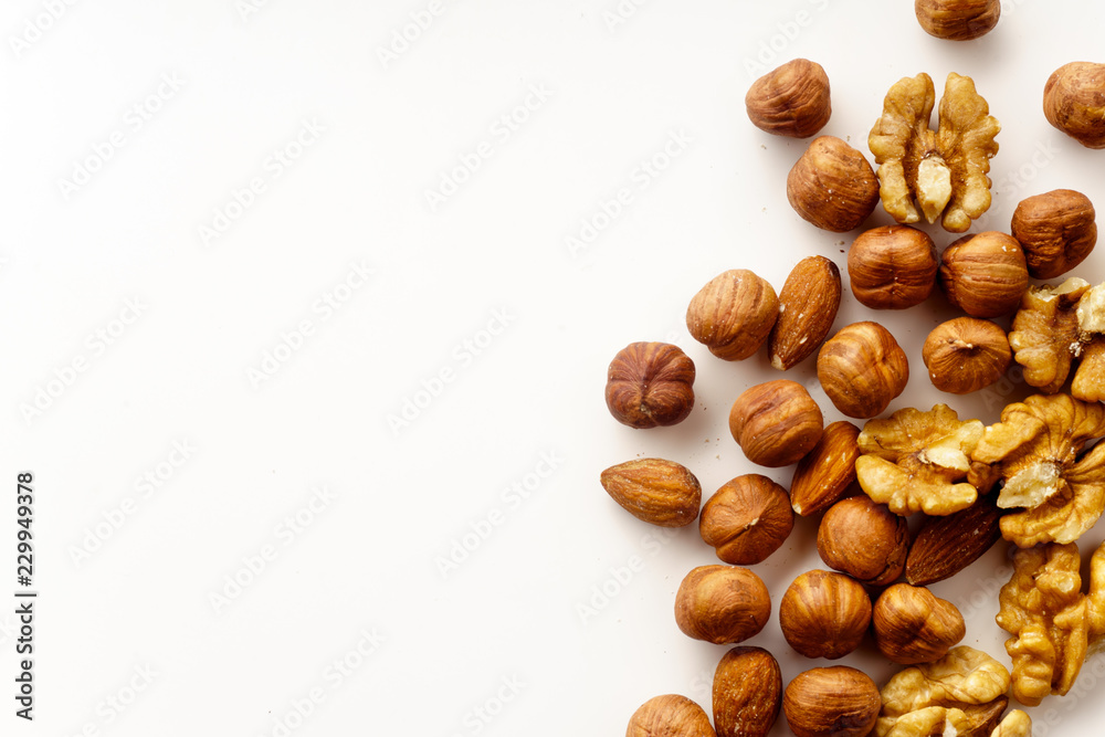 Overhead image of assorted nuts on white background with copy space Overhead image of assorted nuts on white background with copy space
