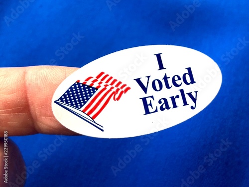 I voted sticker on finger with blue background