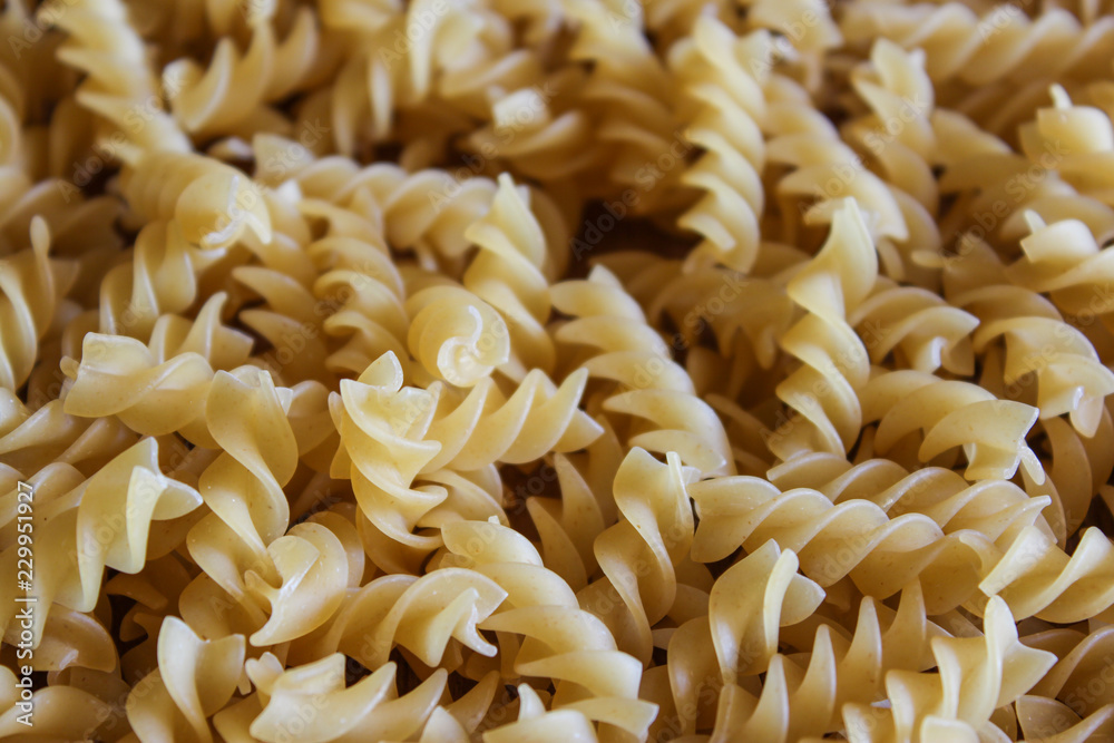 Uncooked fusilli pasta background Uncooked fusilli pasta background