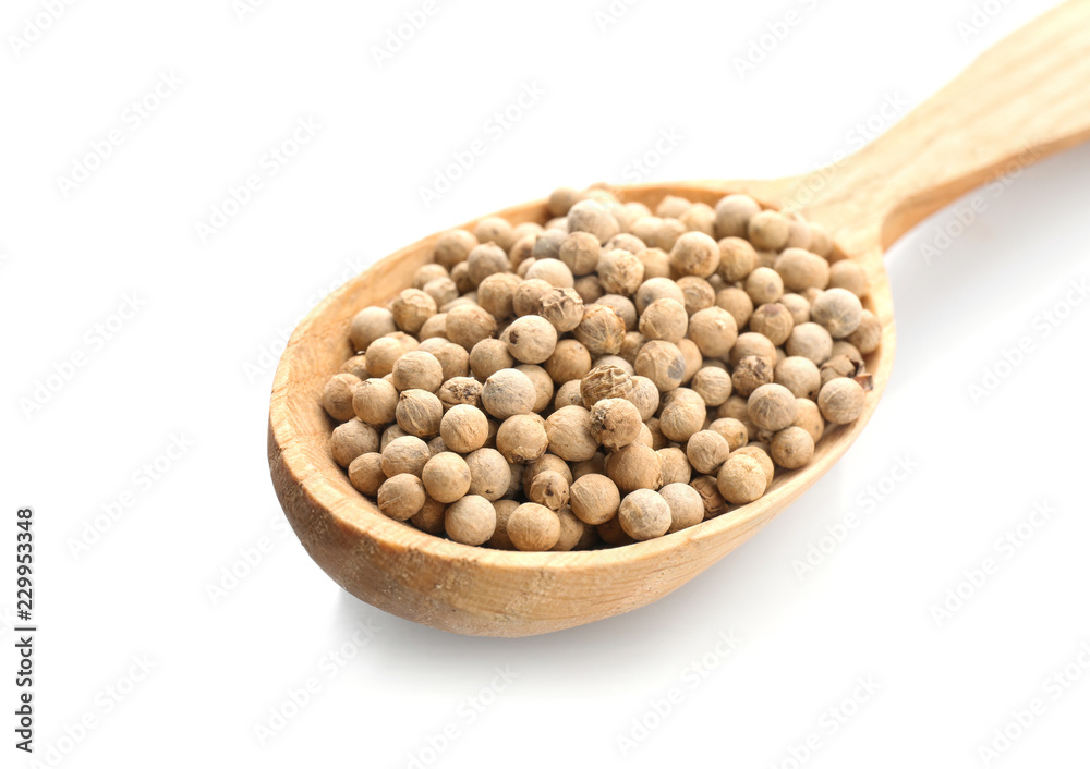Wooden spoon with pepper grains on white background Wooden spoon with pepper grains on white background