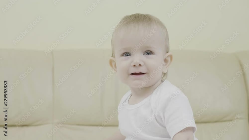 Portrait of baby smiling and looking to camera, blue eyes child Portrait of baby smiling and looking to camera, blue eyes child