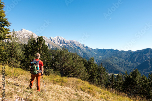 Man hiker is  admiring the range mountains landscape.