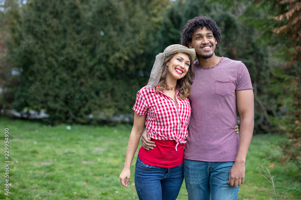 Happy young couple walking in a park