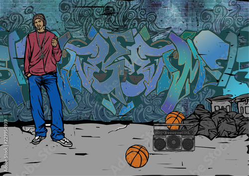Man standing in front of a graffiti covered wall