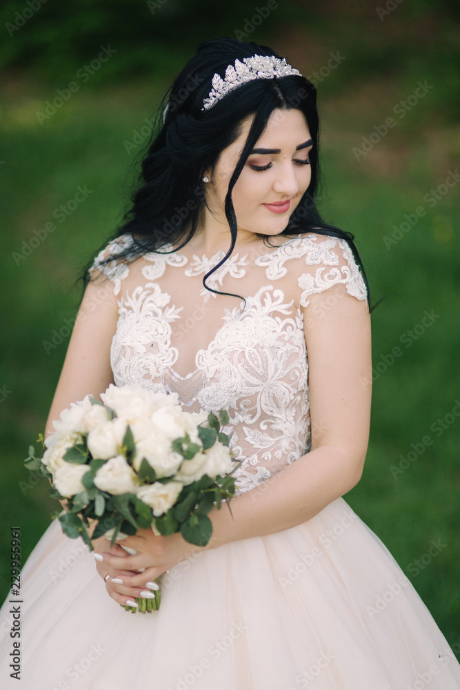 Beautiful bride on her wedding day. Long wedding dress