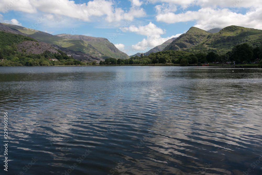 The tranquil blue waters of Llyn padarn, a naturally formed lake in Snowdonia, north Wales
