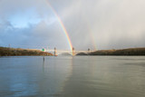 The Britannia Bridge, connecting Anglesey to mainland Wales in the UK, with a rainbow above it on a stormy winter day.